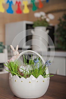 Happy Easter greeting card. Eggs in a nest and Muscari flowers in an Easter basket