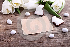 Happy Easter greeting card with white tulip and chocolate eggs and bunny
