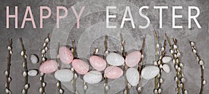 HAPPY EASTER holiday celebration backgroud with text - Pink and white easter quail eggs and catkins on concrete table texture, top