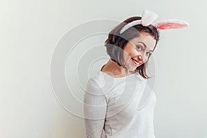 Happy Easter holiday celebration spring concept. Young woman wearing bunny ears isolated on white background. Preparation for
