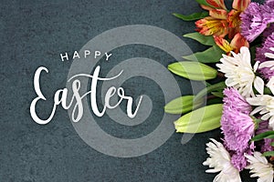 Happy Easter holiday script text over dark background texture and flowers