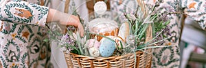 happy easter holiday time in spring season. family and little kids sisters holds basket with painted eggs