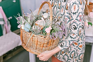 happy easter holiday time in spring season. little eight year old kid girl holds basket with painted eggs