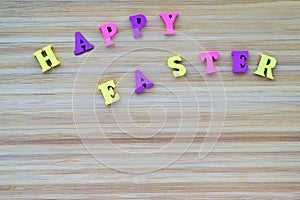 Happy Easter. Inscription made from small, calor, wooden letters.