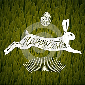 Happy easter jumping rabbit ccalligraphy. grass background.