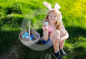 Happy Easter. Kids in bunny ears with Easter egg in basket. Boy play in hunting eggs. easter basket