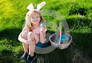 Happy Easter. Kids in bunny ears with Easter egg in basket. Boy play in hunting eggs. easter basket