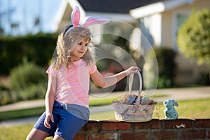 Happy Easter. Kids in bunny ears with Easter egg in basket. Boy play in hunting eggs. Easter holiday.