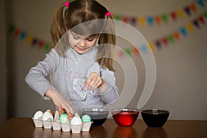 Happy easter. Little girl painter painted eggs. Kid preparing for Easter. Painted hand. Finger paint. Art and craft concept