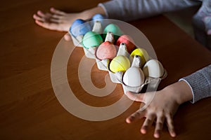 Happy easter. Little girl painter painted eggs. Kid preparing for Easter. Painted hand. Finger paint. Art and craft concept