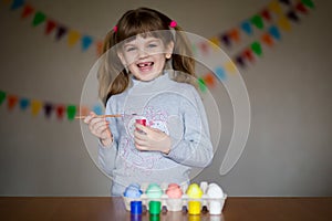 Happy easter. Little girl painter painted eggs. Kid preparing for Easter. Painted hand. Finger paint. Art and craft concept