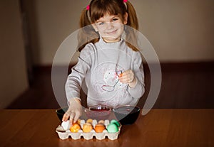 Happy easter. Little girl painter painted eggs. Kid preparing for Easter. Painted hand. Finger paint. Art and craft concept.