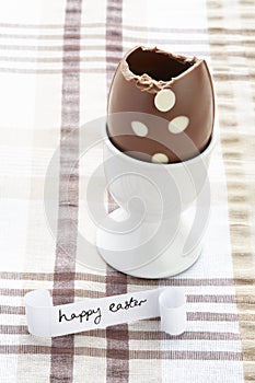 Happy easter message with half eaten chocolate egg