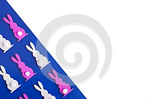 Happy easter minimal concept. White and pink easter bunnies on a blue and white background. Copy space for text