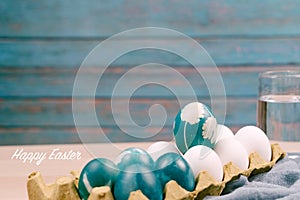 Happy easter, organic blue easter egg standing on the white color eggs wait for painting, easter holiday decorations