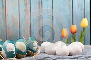 Happy easter, organic easter eggs wait for painting with blue easter eggs, easter holiday decorations, easter concept backgrounds