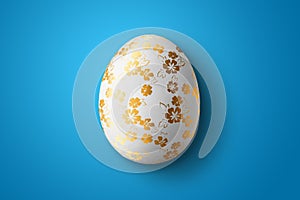 Happy Easter, painted Easter egg on a blue background. White gold pattern.