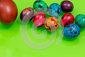 Happy Easter. painted eggs of different colors on a green background, decoration, Place for text