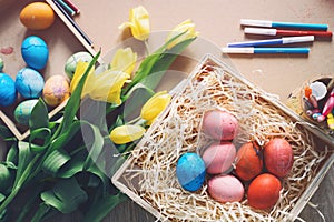 Happy Easter! Paints, felt-tip pens, flowers, decorations for coloring eggs for holiday - easter background of real live.