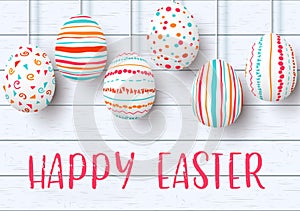 Happy Easter. pending easter eggs on white wooden background. Easter colorful hanging