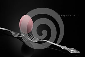 Happy Easter,pink egg two forks ancient silver on a black
