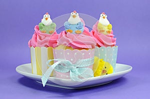 Happy Easter pink, yellow and blue cupcakes with cute chicken decorations