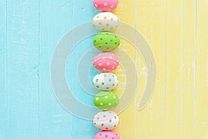 Happy easter! Row Easter eggs with colorful paper flowers