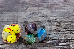 Happy Easter with Rustic still life - easter eggs with birds nest on an old wooden board. Spring, Easter concept