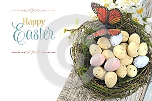 Happy Easter shabby chic table with speckled birds eggs and butterfly in nest