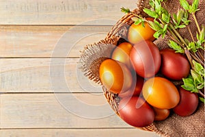 Happy Easter. Shiny golden eggs in a wicker basket and willow twigs