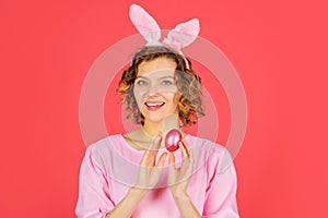 Happy Easter. Smiling girl with pink egg. Spring holiday. Woman in rabbit bunny ears. Hunting eggs.