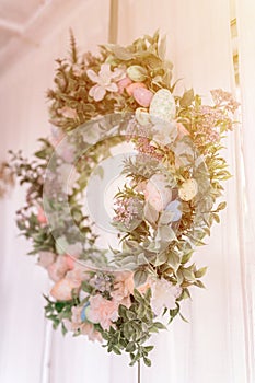 happy easter and spring holidays time. easter wreath with sprigs of lilac bush blossom flowers and leaves