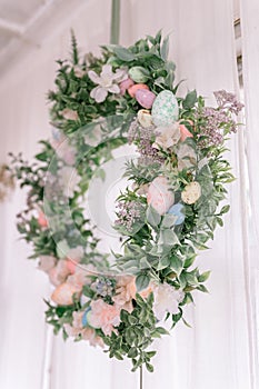 happy easter and spring holidays time. easter wreath with sprigs of lilac bush blossom flowers and leaves