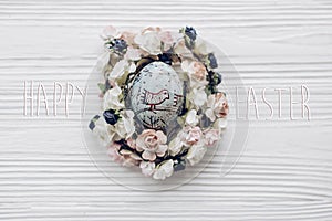 Happy easter text greeting card sign on easter egg with chick or