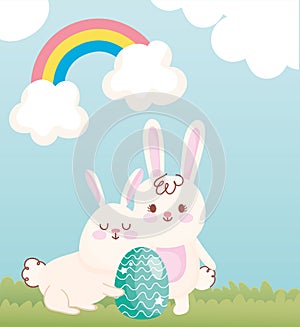 Happy easter white bunnies with green egg in the field rainbow sky decoration