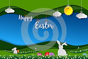 Happy Easter with white rabbits,colorful eggs and little daisy in the meadow,landscape paper art background