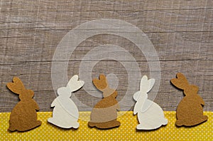 Happy easter: wooden background with rabbits for a greeting card