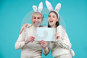 Happy easter for your company. Bunny: upset rabbit couple. Portrait of happy Easter bunny man and woman hold board paper