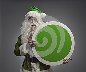 Green eco-friendly Santa holding a blank sign