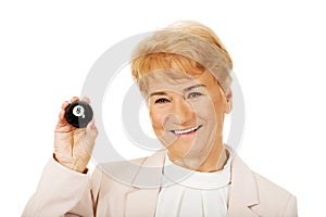 Happy elderly business woman holding eight billard-ball