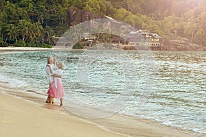 Happy elderly couple dancing on tropical beach