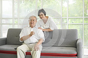 Happy elderly couple drinking milk and spending time together at home, health and retirement concept