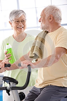 Happy elderly couple in the gym