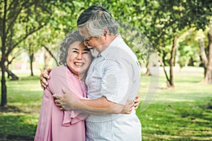 Happy elderly couple with lifestyle after retiree concept. Lovely asian seniors couple embracing together in the park.