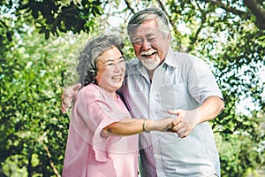 Happy elderly couple with lifestyle after retiree concept. Lovely asian seniors couple embracing together in the park.