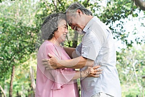 Happy elderly couple with lifestyle after retiree concept. Lovely asian seniors couple embracing together in the park.