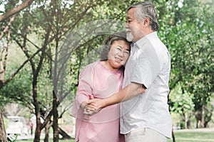 Happy elderly couple with lifestyle after retiree concept. Lovely asian seniors couple embracing together in the park.