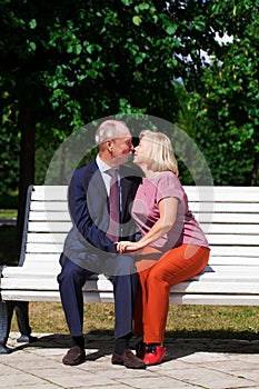 Happy Elderly couple resting on a bench