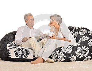 Happy elderly couple resting at home