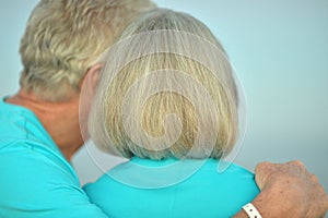 Happy elderly couple resting on tropical beach